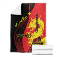 Red and black blanket with Eiffel Tower, dragon flame artwork and star accents, folded