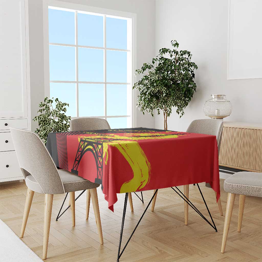 Red tablecloth over dining table with Eiffel Tower arch and yellow dragon graphic