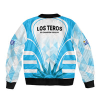 Light blue bomber jacket, black ribbed hem and cuffs; Los Teros back graphic and flag patch