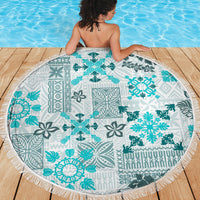 Round beach blanket featuring aqua snowflake floral tribal motifs on white, fringe border