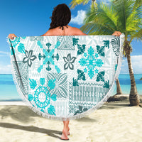 Circular beach blanket held up, white with aqua tribal quilt pattern and fringed rim