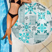 Round aqua-and-teal tribal quilt beach blanket on white with white fringe border