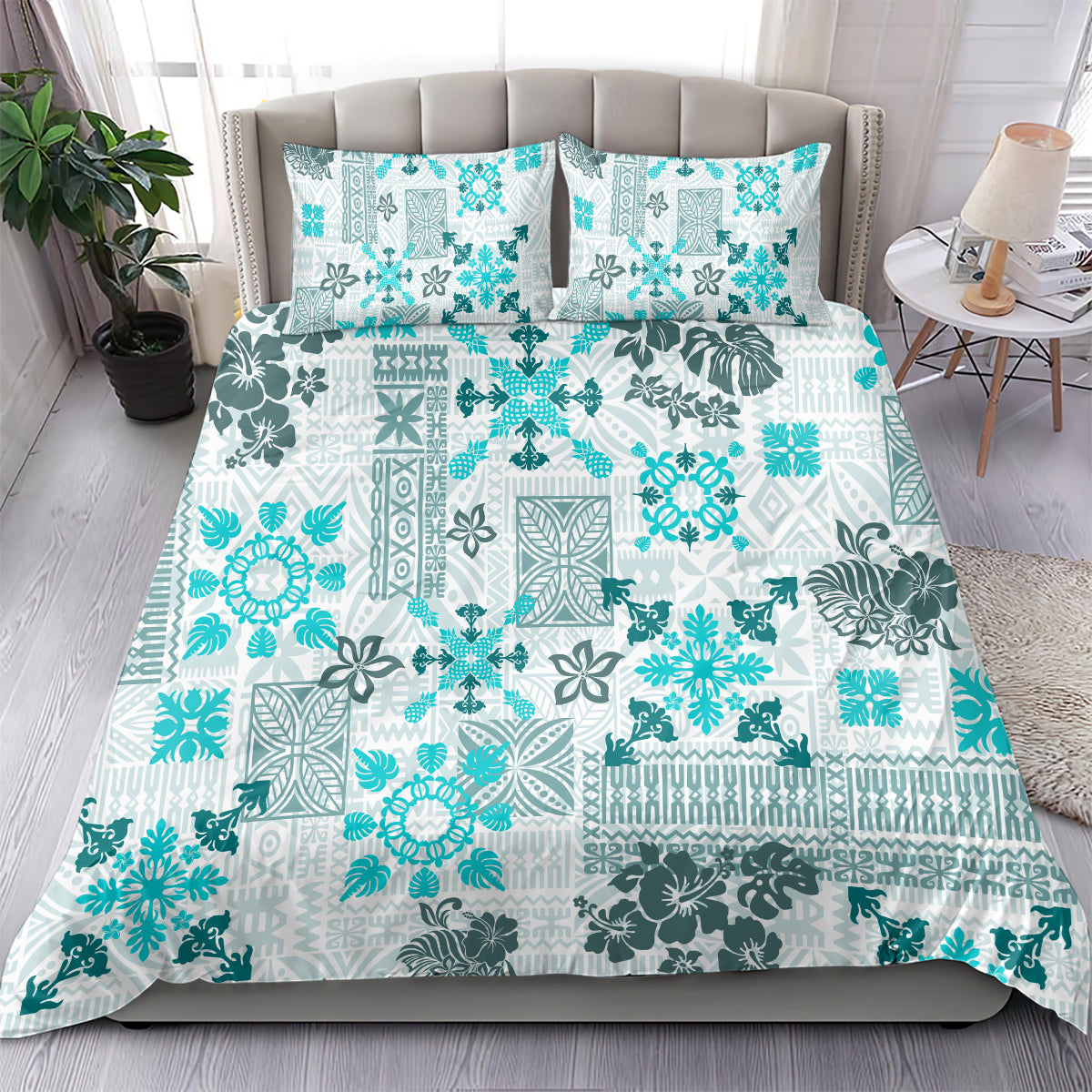 Aqua and white tribal quilt bedding set with two pillow shams, spread on bed