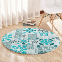 Round aqua carpet with tapa tribal quilt pattern, large teal snowflake-like motifs
