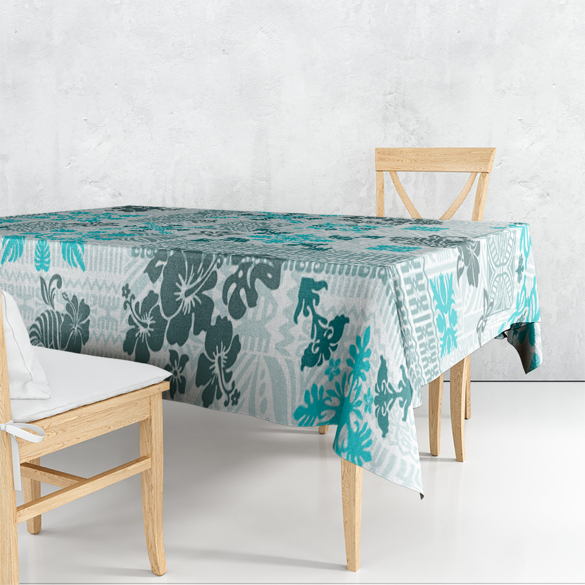 Aqua tablecloth draped on dining table with teal floral and tribal patchwork pattern