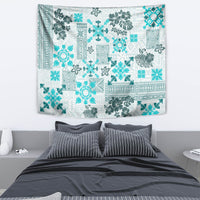 Aqua and white quilt-style tribal tapestry with floral and geometric patchwork motif