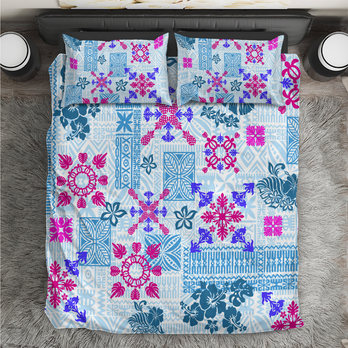 Blue quilt bedding set with colorful floral and tribal patchwork pattern, two pillowcases.