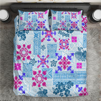 Blue quilt bedding set with colorful floral and tribal patchwork pattern, two pillowcases.