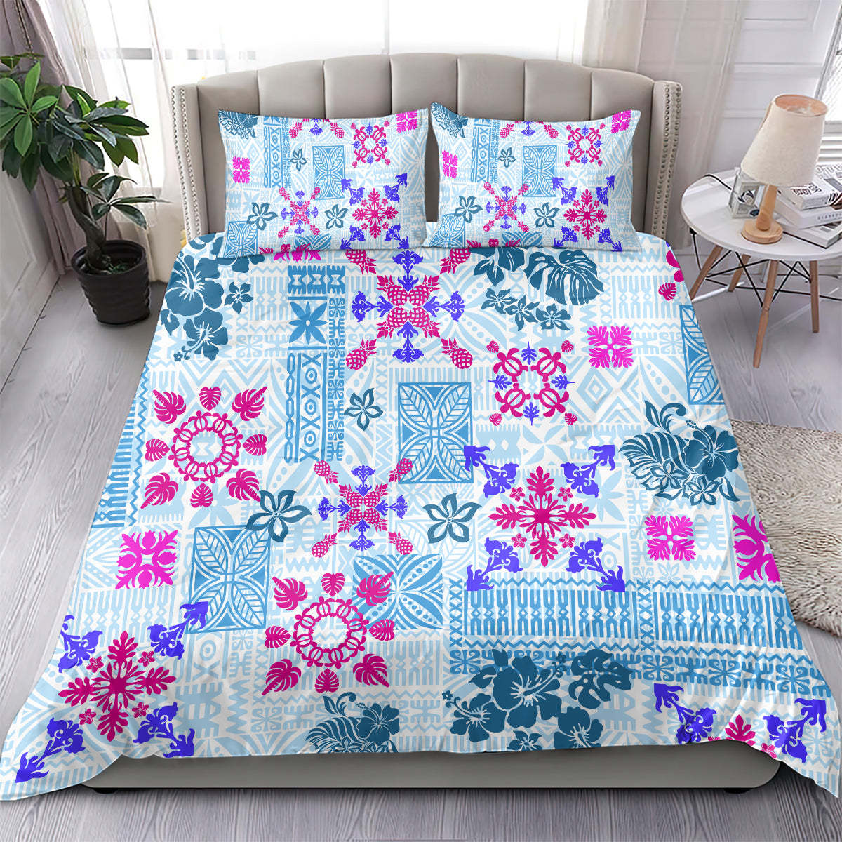 Blue and magenta tribal floral quilt bedding set with two matching pillowcases on bed.
