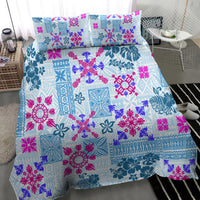 Blue Hawaiian-style quilt bedding set with pink and purple floral patterns, two pillowcases.