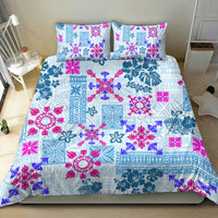 Blue patchwork quilt bedding set with magenta floral motifs and two square pillowcases.