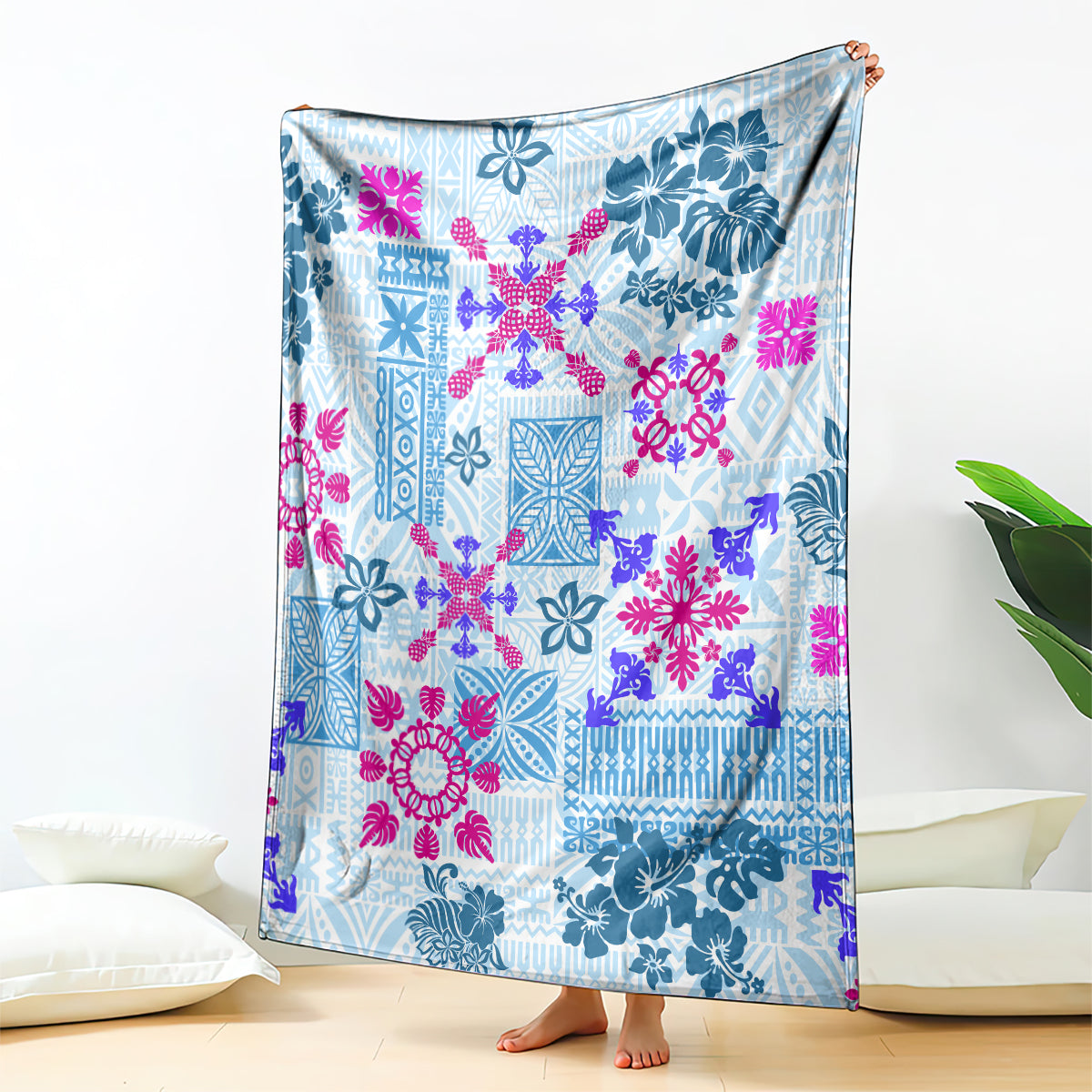 Blue tapa quilt blanket with floral tribal pattern, draped over floor couch