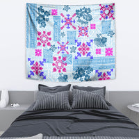 Blue rectangular quilt tapestry with pink and teal floral-geometric patchwork pattern