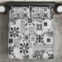 Top view of black-and-white tribal quilt bedding set with two pillowcases