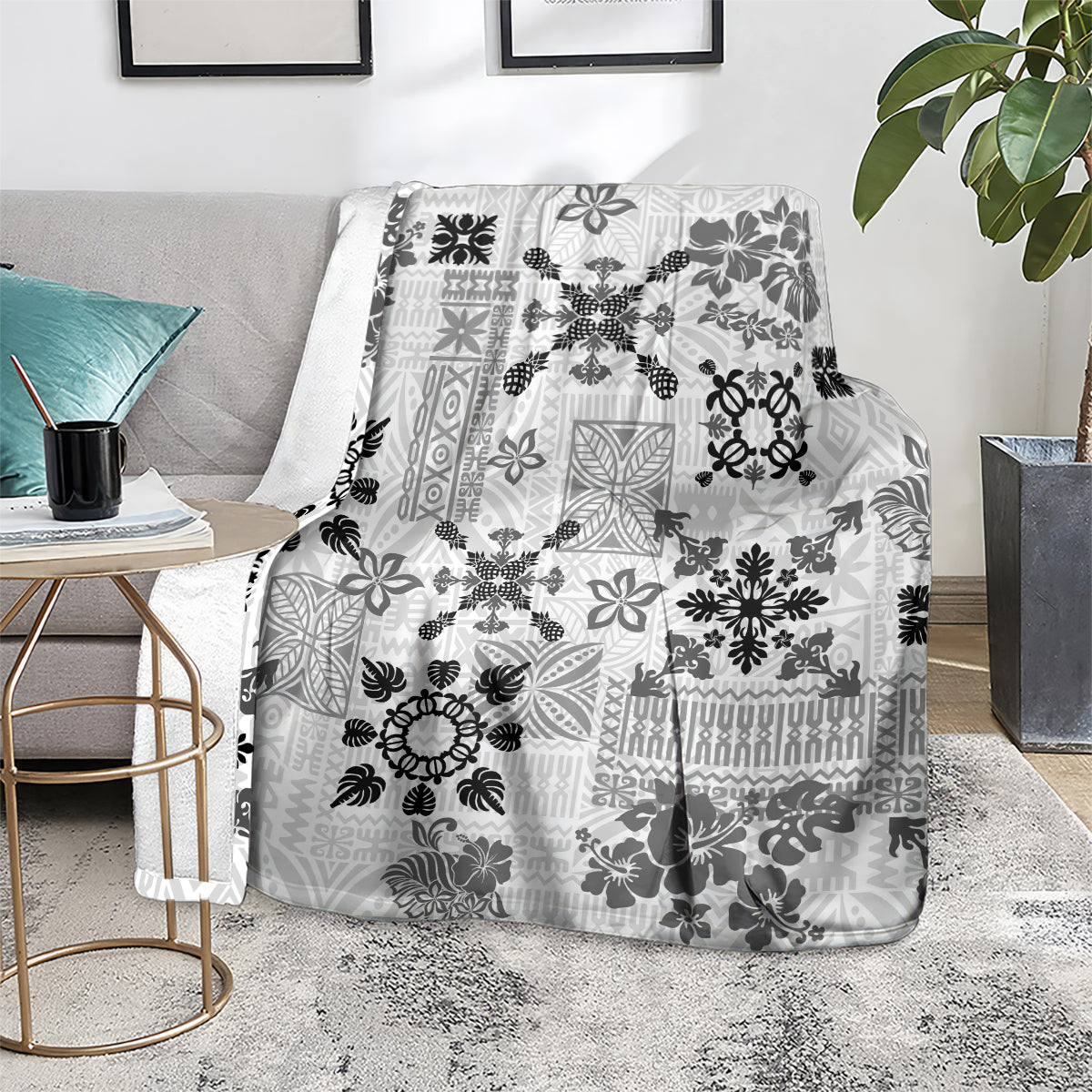 Black and white Hawaiian tapa tribal quilt blanket draped over a sofa