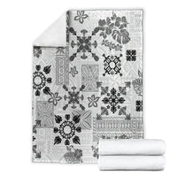 Black and white Hawaiian quilt blanket folded with tapa floral tribal pattern