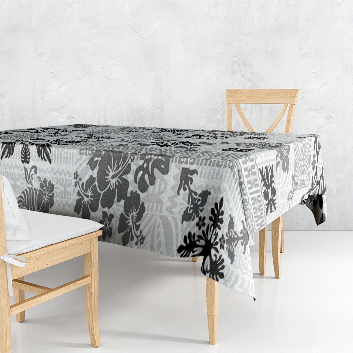 Black and white tribal quilt tablecloth with floral tapa pattern draped over table