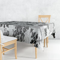Black and white tribal quilt tablecloth with floral tapa pattern draped over table