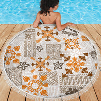 Round beach blanket, white with orange-brown tapa and geometric quilt pattern, fringed border