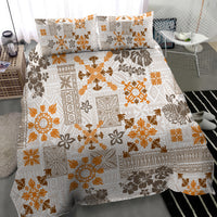 Gold and white tapa print quilt bedding set with decorative tribal motifs