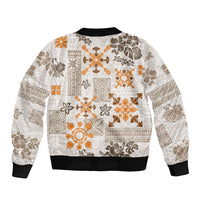 Unisex bomber jacket, front zip and black ribbed cuffs, white with orange tribal quilt print.