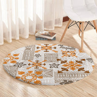 Round area rug with beige field and orange-brown tapa tribal quilt pattern, textured border
