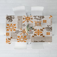 Square tablecloth with tropical tapa tribal print, brown and orange motifs on off-white.