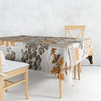 Rectangular tablecloth with tropical tapa tribal pattern, brown and orange on off-white.