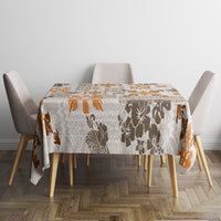 Square tablecloth with tapa tribal quilt pattern, brown and orange motifs on off-white.