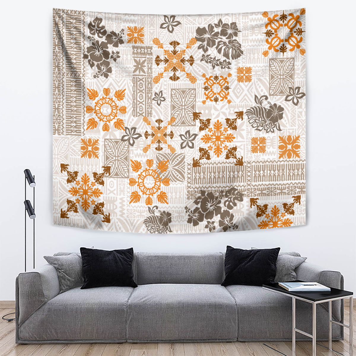 Fringed quilt-style tapestry with white, orange, and dark brown geometric floral design