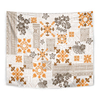Close-up fringed tapestry showing white, orange, and dark brown quilt patchwork pattern