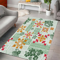 Rectangular green Hawaiian-style area rug with tapa tribal quilt pattern in orange and red