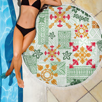 Round beach blanket with fringe edge, green Hawaiian quilt pattern with red and orange details