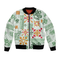 Green bomber jacket with zip front, black ribbed cuffs, tropical quilt print.