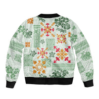 Green bomber jacket with tropical quilt pattern, black ribbed hem and sleeves cuffs.