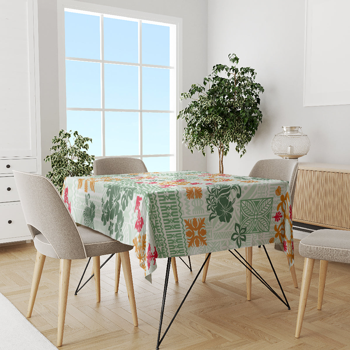 Green quilt-style tablecloth with tapa tribal pattern and multicolor floral accents