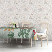 Green Hawaiian tablecloth featuring tapa tribal blocks, floral leaves, and red accents