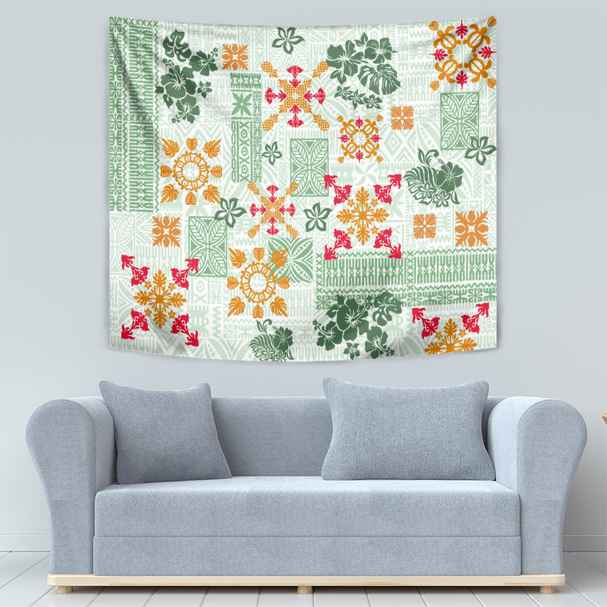 Green quilt-pattern tapestry on wall above gray sofa; orange, red, and white motifs