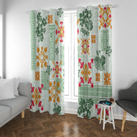 Green patterned window curtains with tapa and floral quilt design in red, orange, white