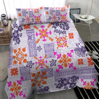 Violet quilt with vibrant tapa tribal motifs and two matching pillow shams.