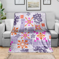Purple-toned tropical blanket with violet, orange, and pink tapa and flower patchwork
