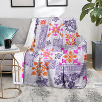 Violet Hawaiian quilt blanket with orange and pink floral tapa motifs and dark purple borders