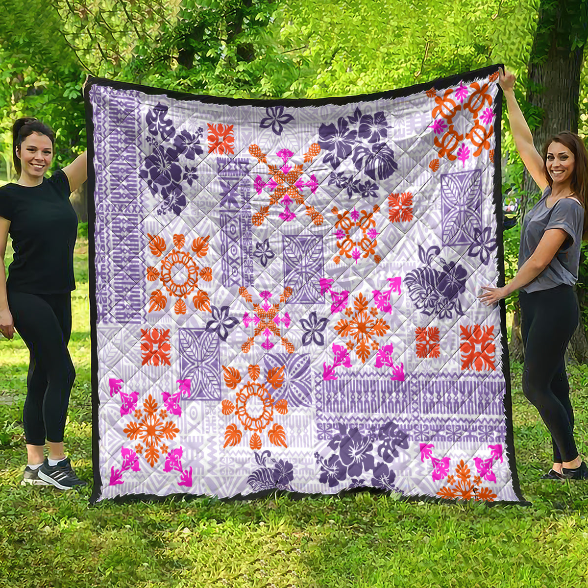 Violet quilt draped outdoors with white geometric tapa pattern and bright orange and pink flowers