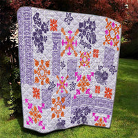Violet quilt blanket with white and purple tapa design and orange, pink, and magenta flower shapes