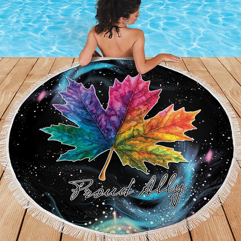 Round black beach blanket with rainbow maple leaf artwork and white fringe border