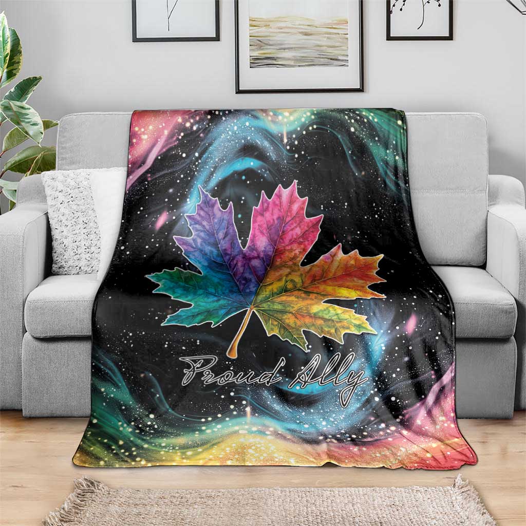 Rainbow maple leaf throw blanket on sofa with galaxy swirls and Proud Ally text