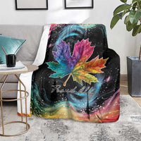 Black rainbow maple leaf blanket with bright leaf and starry nebula design on floor