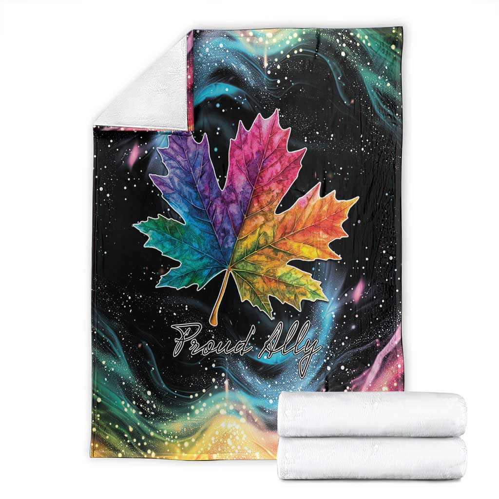 Rainbow maple leaf blanket with large colorful leaf, starry pattern, and folded white towels