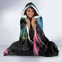 Black hooded blanket with rainbow maple leaf design, worn with hood and white sherpa trim