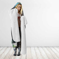 White sherpa-lined hood on black hooded blanket with rainbow galaxy maple leaf print